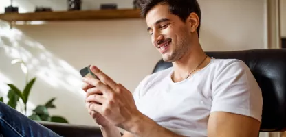 Man on his phone smiling