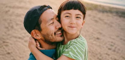 Father and daughter hugging on the beach